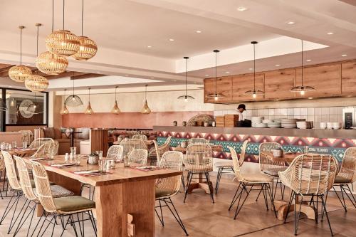 a restaurant with wooden tables and chairs and a counter at Atlantica Caldera Palace in Hersonissos