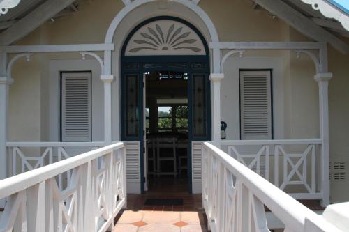 a front door of a house with a white fence at The Villa at Caribbean Estates in Port Edward