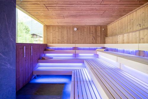 a sauna with purple benches and a window at Der Postwirt in Söll