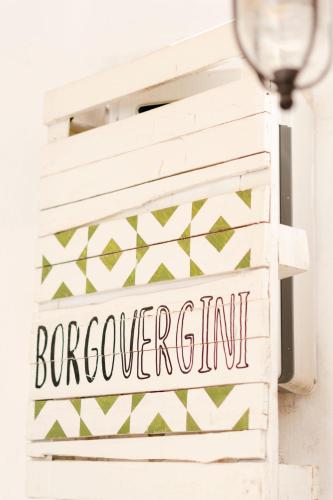 a sign for a bedroom with a geometric pattern at Borgo Vergini Garden B&B in Naples