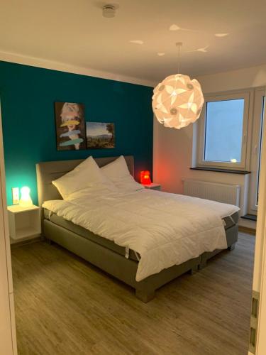 a bedroom with a large bed with a green wall at Apartment im Zentrum in Kassel