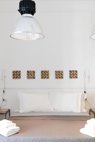 a room with a bed and a pendant light at Borgo Vergini Garden B&B in Naples