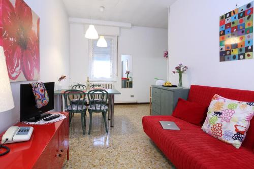 a living room with a red couch and a table at Residence Giusti 6 in Milan