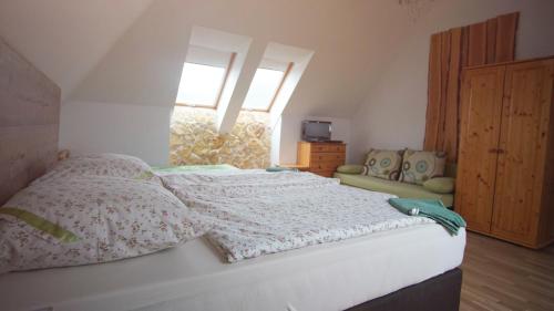 a bedroom with a bed with pillows and a window at GRANÁRIUM in Jablonov nad Turnou