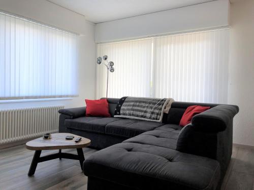 a living room with a couch and a table at Les Dents-du-Midi in Monthey