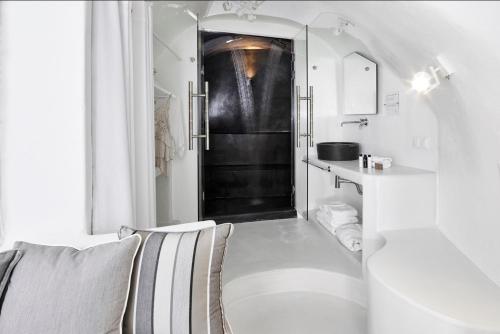 a white toilet sitting next to a white sink at Dana Villas & Infinity Suites in Firostefani