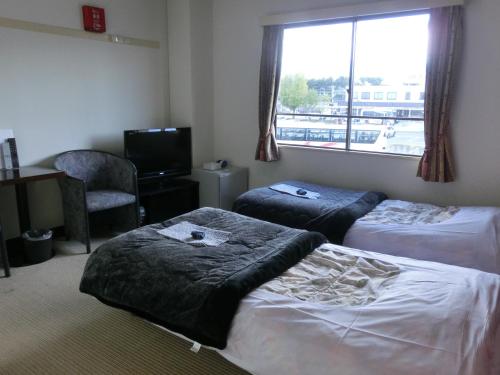 Кровать или кровати в номере Biz Hotel Shiojiri Ekimae