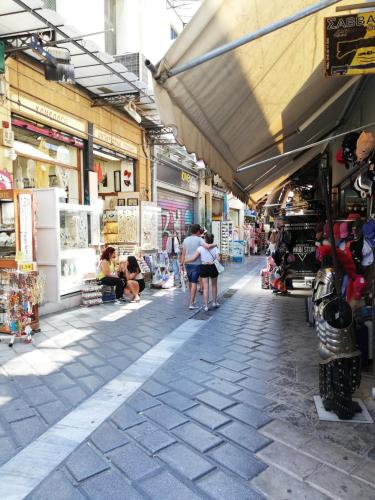 a group of people walking through a market at Muse Urban Suites in Athens