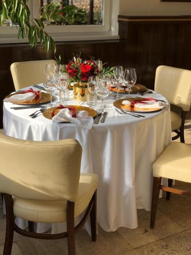 a table with a white table cloth and wine glasses at Hotel U Šuláka in Brno