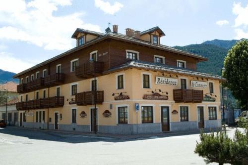 a large building with balconies on top of it at Residence Du Commerce in Oulx