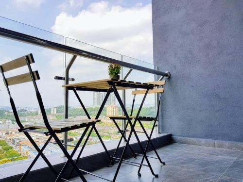 a table and a chair on a balcony at Skypod Residence Puchong in Puchong