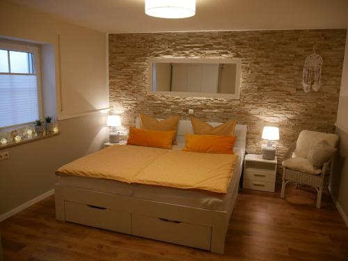 a bedroom with a bed and a brick wall at Haus Alexandra in Schwarzenbach an der Saale