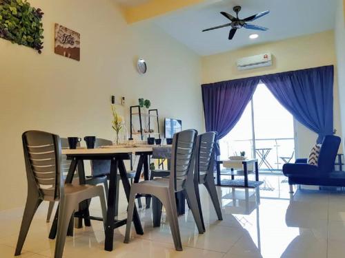 a dining room with a table and chairs at Skypod Residence Puchong in Puchong