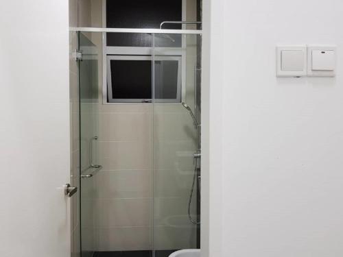 a bathroom with a glass shower with a toilet at Skypod Residence Puchong in Puchong