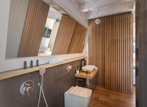 a bathroom with a sink and a mirror at Iancu Charme Apartments in Taormina