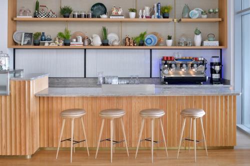 a kitchen with a counter with bar stools at Vida Creek Harbour in Dubai
