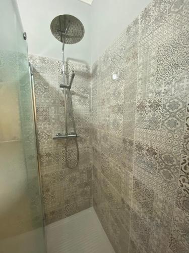 a shower with a shower head in a bathroom at Vittorio Veneto Accomodation - Tropea city center in Tropea