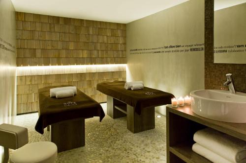 a bathroom with a sink and a tub and a toilet at Heliopic Hotel & Spa in Chamonix-Mont-Blanc