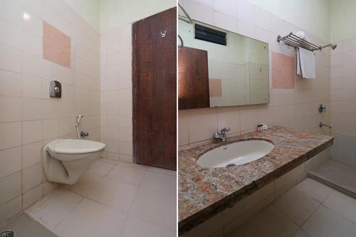 a bathroom with a toilet and a sink at King's Queen Crown Mandarmoni in Mandarmoni