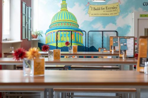 a room with tables with a dome on the wall at YHA London St Paul's in London