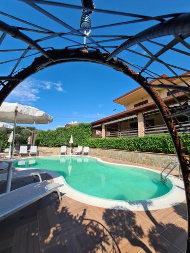 a swimming pool in a resort with an archway at B&B Artemide in Agropoli