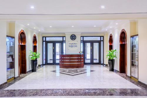 a lobby with a reception desk in a building at Sedra Arjaan by Rotana in Doha