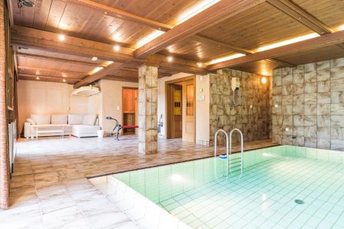a pool in a house with a wooden ceiling at Yes, it is RETRO - Big Villa with Indoor Pool in Vienna