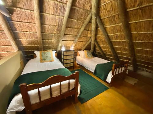 A bed or beds in a room at ParkView Safari Lodge