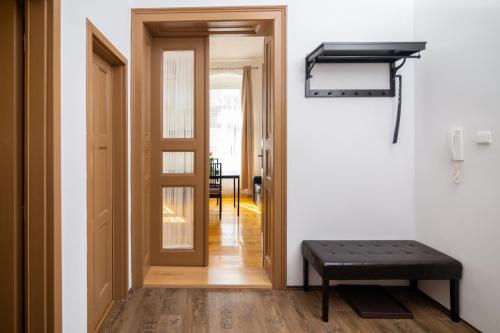 a hallway with a door and a bench in a room at Golden Key Apartments in Liberec