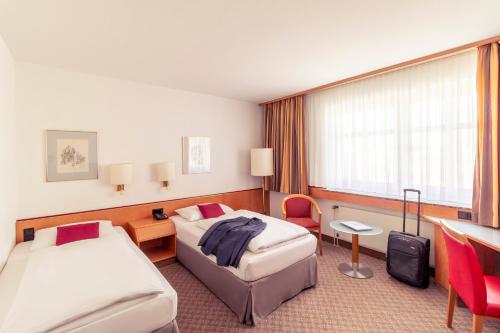 Ένα ή περισσότερα κρεβάτια σε δωμάτιο στο Mercure Hotel Köln City Friesenstraße