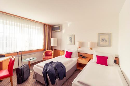 Ένα ή περισσότερα κρεβάτια σε δωμάτιο στο Mercure Hotel Köln City Friesenstraße