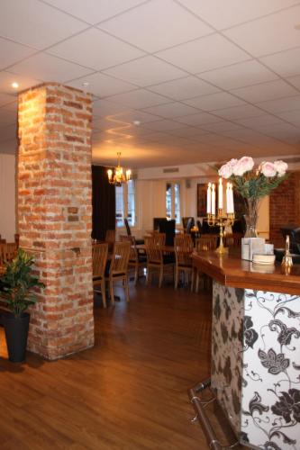 a brick pillar in a restaurant with tables and chairs at Grännagården in Gränna