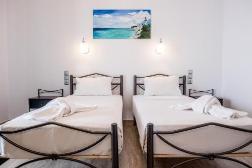 Amousso Beach Villas tesisinde bir odada yatak veya yataklar