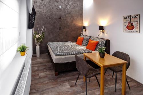 a small room with a bed and a table at Golden Key Apartments in Liberec