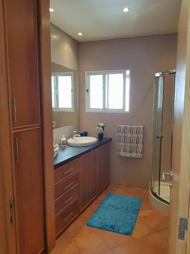a bathroom with a sink and a shower at Home Sweet Home in Ribeira Grande