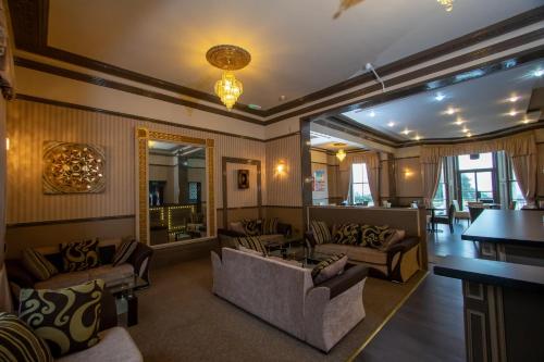 a living room with couches and a table at The Carlton Hotel in Folkestone