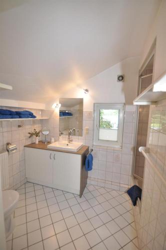 a bathroom with a sink and a toilet at Ferienwohnungen Abraham in Lübeck
