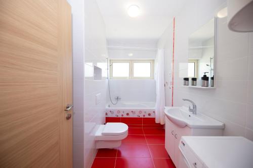 a white bathroom with a toilet and a sink at Villa francesca in Starigrad