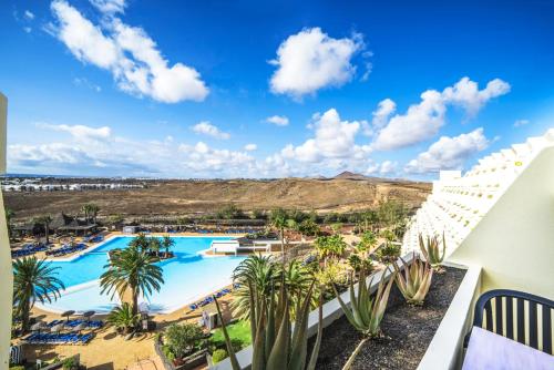 a view of the pool from the balcony of a resort at Beatriz Costa & Spa in Costa Teguise