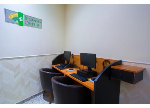 an office with a desk with two computers on it at Leques Brasil Hotel Escola in Sao Paulo