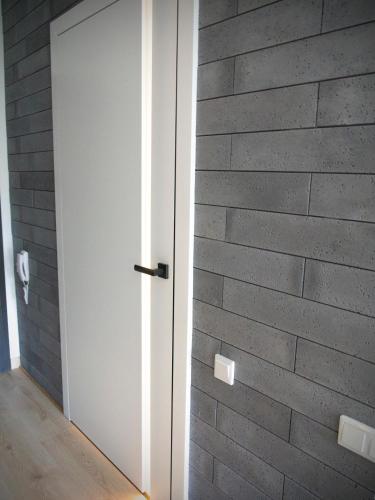 a white door in a brick wall at Albus 312 in Świnoujście
