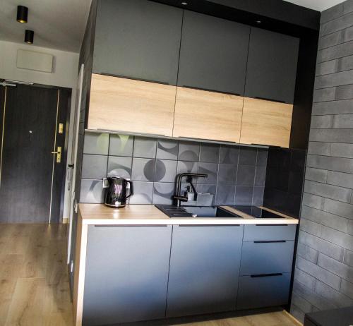a kitchen with a sink and a counter top at Albus 312 in Świnoujście
