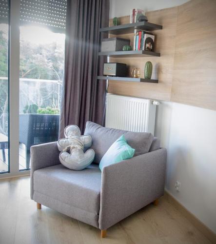 a couch with a stuffed animal on it in a living room at Albus 312 in Świnoujście