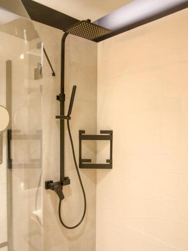 a shower with a shower head in a bathroom at Albus 312 in Świnoujście