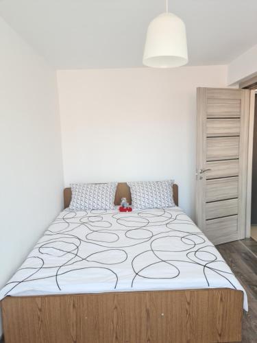 a bedroom with a large bed in a room at Apartament In Inima Dornei in Vatra Dornei