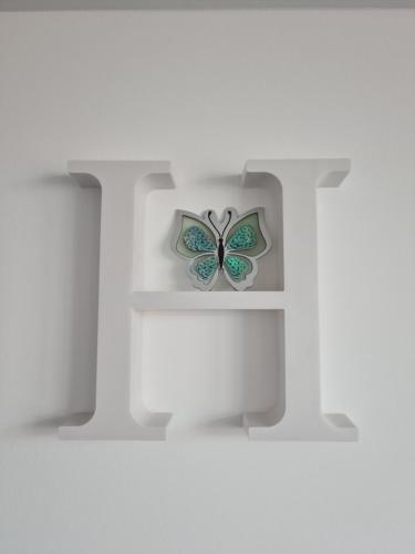 a butterfly on a shelf in a white room at Apartament In Inima Dornei in Vatra Dornei