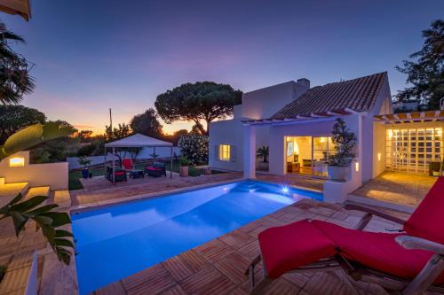 a villa with a swimming pool at night at Villa AL Fresco in Guia