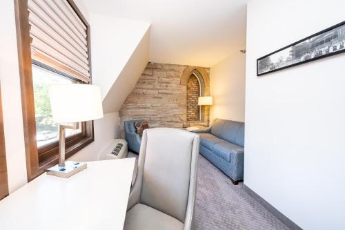 a living room with a couch and a table at The Inn at Shattuck - St. Mary's in Faribault