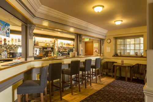 a bar in a restaurant with a bunch of chairs at Sea Shore Lodge Mudeford in Christchurch