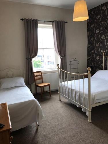 a bedroom with two twin beds and a window at Coach and Horses in Barnard Castle